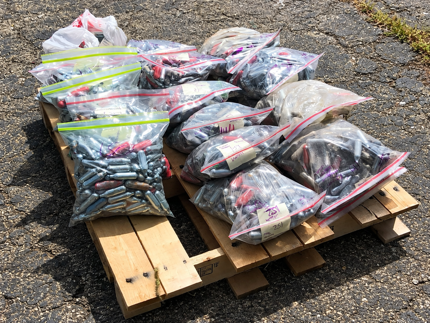 Bags of discarded whippet cartridges collected during a community cleanup