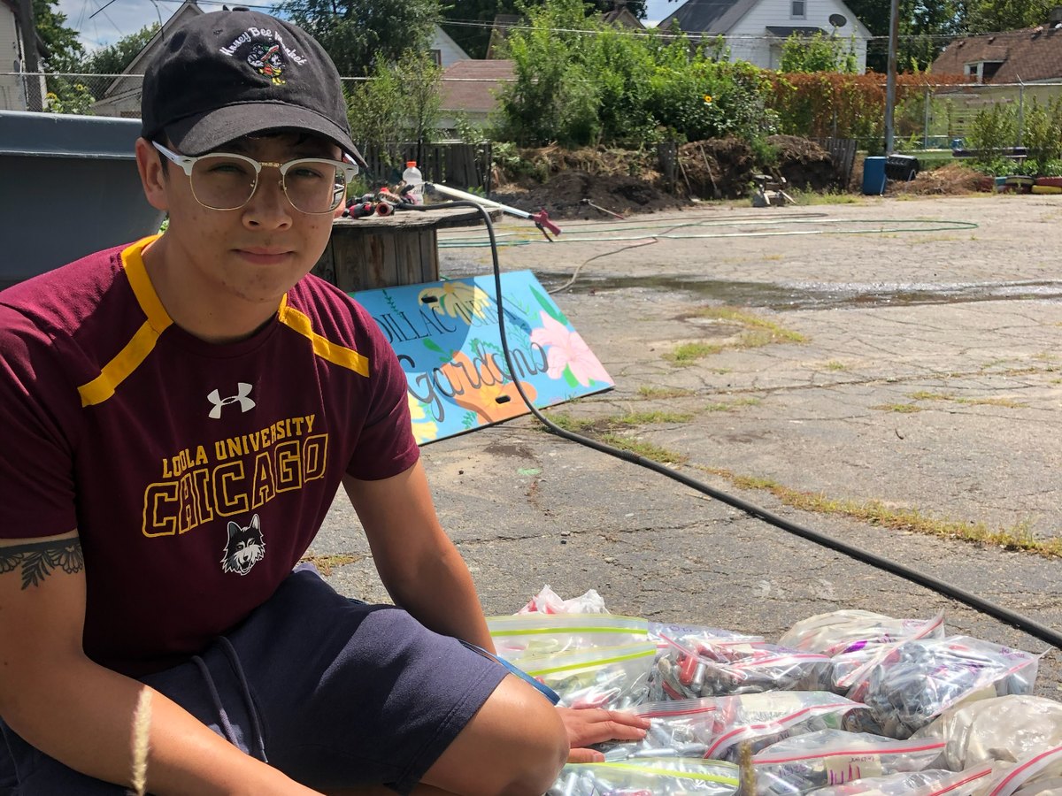 Volunteer at a community collection site with bags of discarded whippet cartridges